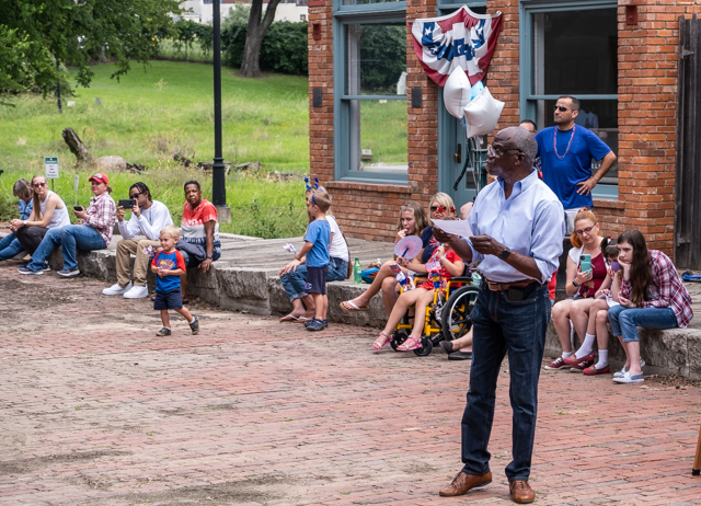 Michael telling a story on a brick plaza